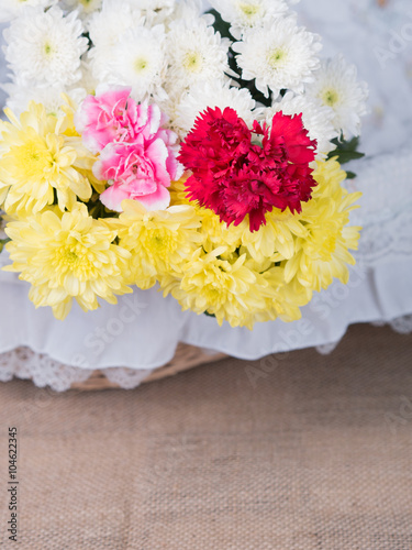 Red flowers on table of flower arrangement.