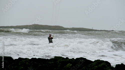 Kite surfers are surfing on large storm waves in North Wales as a stormy winter hits. photo