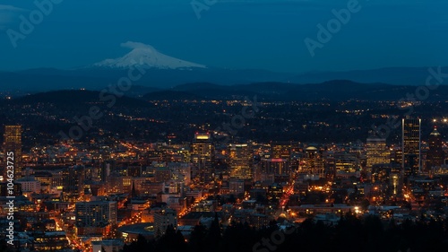UHD 4k time lapse movie of auto traffic and light trails over snow covered Mt. Hood and city of Portland Oregon from daylight into blue hour 4096x2304