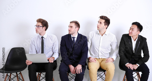 Young businessmen sitting o...