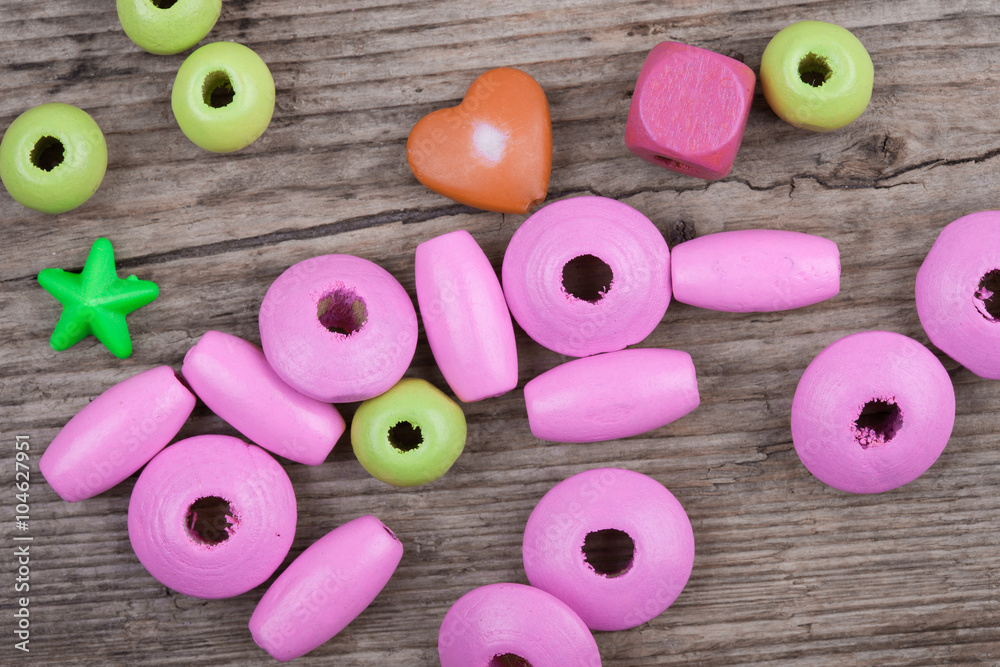 macro backdrop of little toy beads on wooden background macro backdrop of little toy beads on wooden background