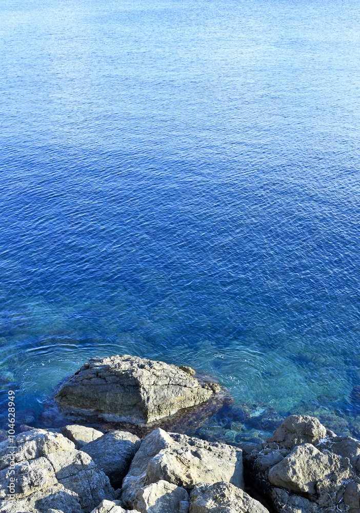 Rocky coastline background and clear blue and turquoise sea with copy space. Rocky coastline background and clear blue and turquoise sea with copy space.