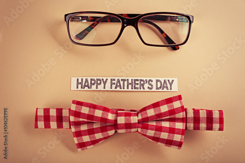 Happy fathers day sticker, bow tie, glasses on beige background