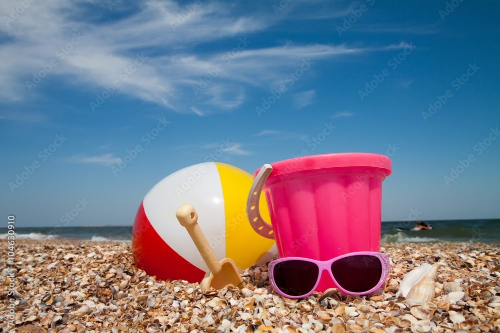 Child's bucket and toys on tropical beach Child's bucket and toys on tropical beach