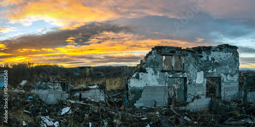 The remains of destroyed houses at sunset