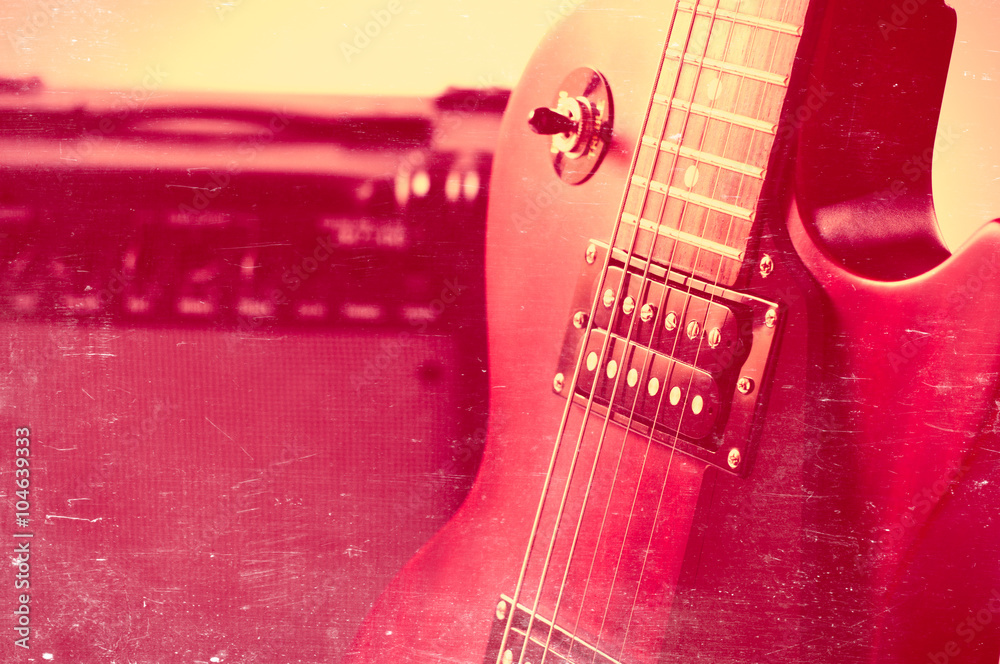 Fototapeta premium Part of electric guitar on wooden background. Old style