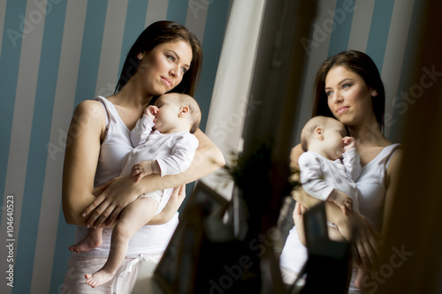 Happy mother with newborn baby girl