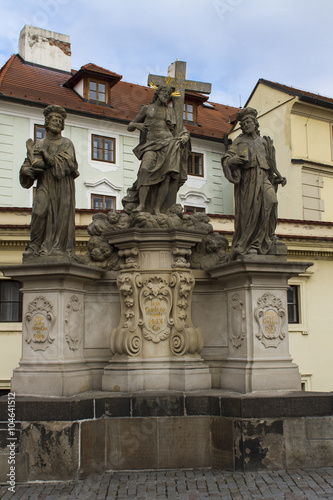 Statue of the Holy Savior with Cosmas and Damian at Charles Bridge in Prague
