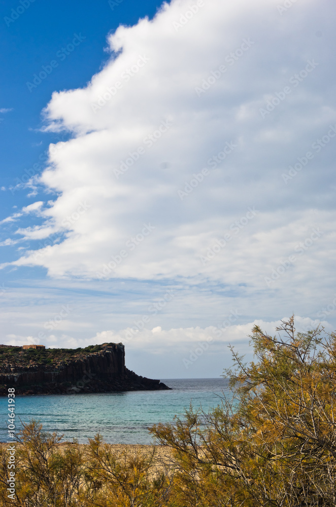Cliffs at the end of sandy beach in San Pietro island, Sardinia, Italy