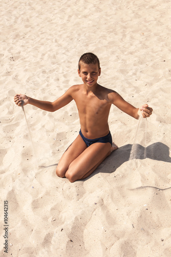 Happy boy enjoying sunny day at the beach