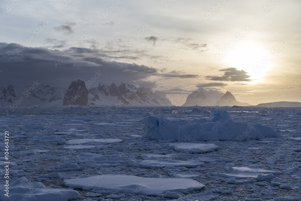 Drifting ice floes in sunset at Lemaire Channel, Antarctica.