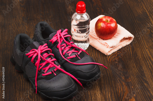 Sneakers, apple and bottle of water