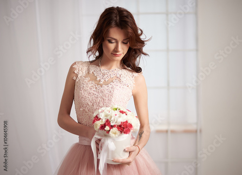 Bride in a pink dress with flowers