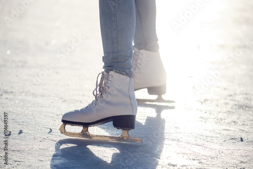 Closeup of young girl on the figure skates outdoor in sunny spring day