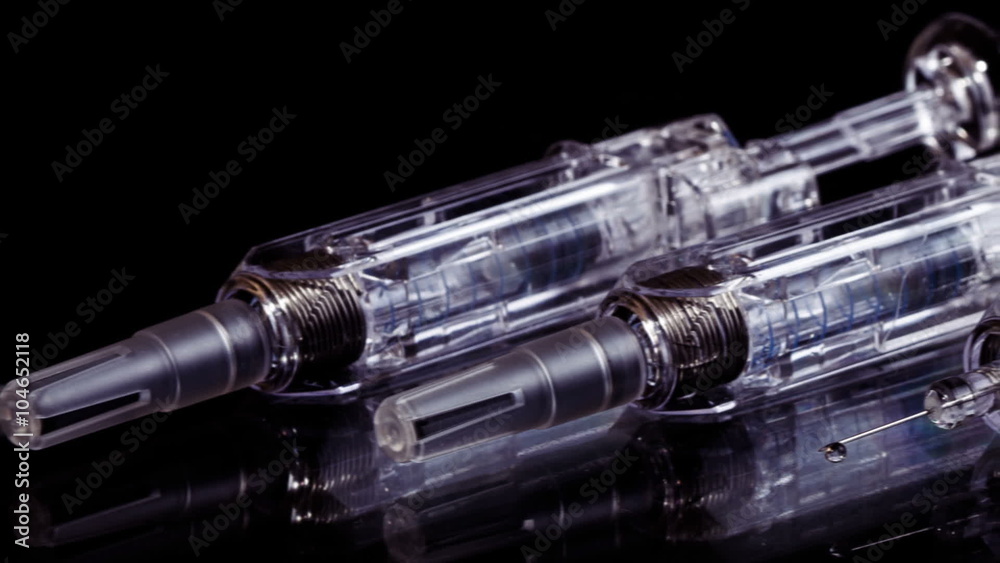 Three Glass Syringes Isolated on Black Background, Slider View Three Glass Syringes Isolated on Black Background, Slider View