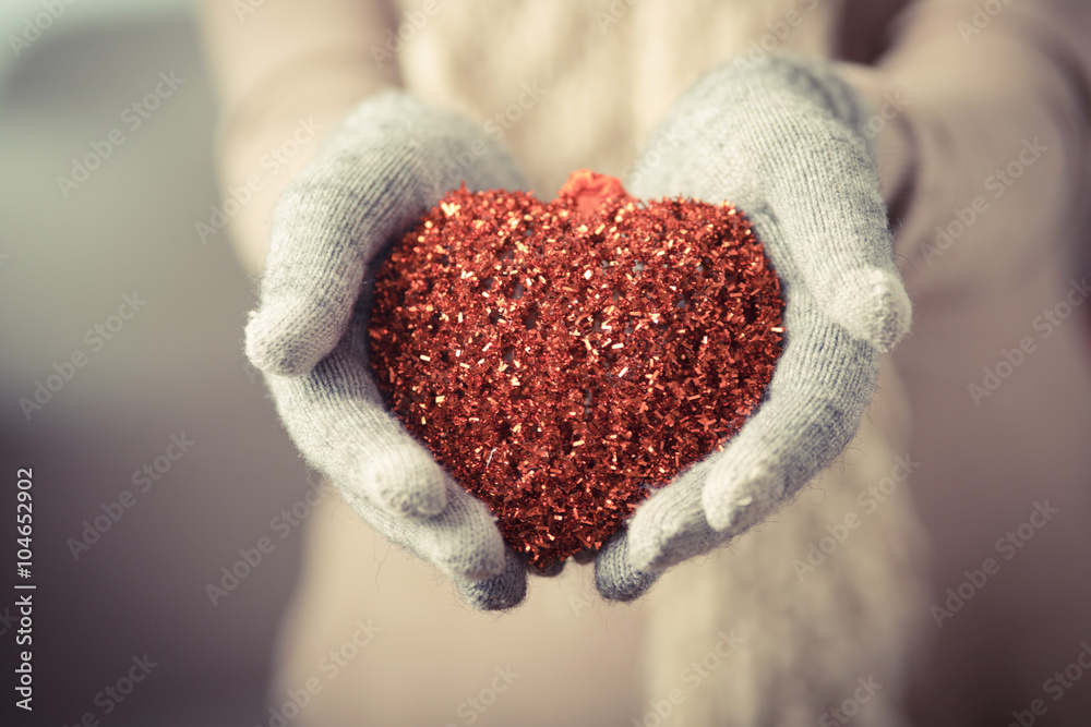 Fototapeta premium Female hands in mitten with heart