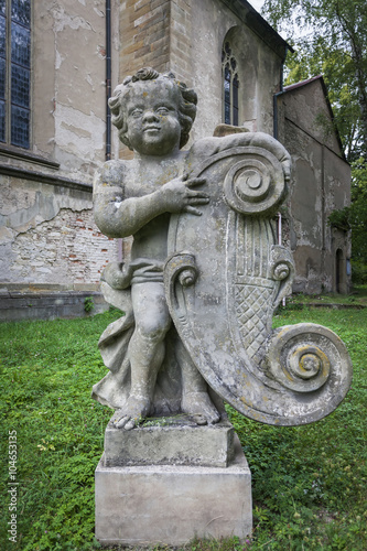 Old sculpture in the park next to the church