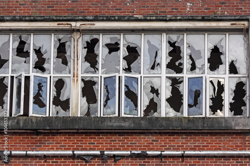 Photos Rows of shattered windows in an abandoned factory building in UK