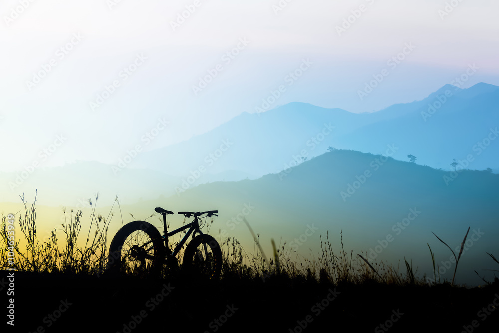 Obraz premium beautiful sunset sky and mountain bike silhouette , silhouette fat bike