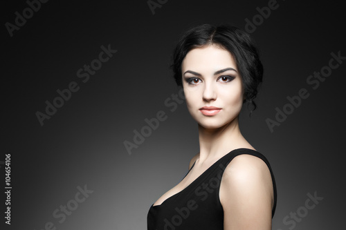 Portrait of beautiful female model on gray background