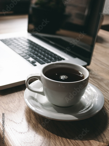 Cup of Black Coffee Beside Laptop