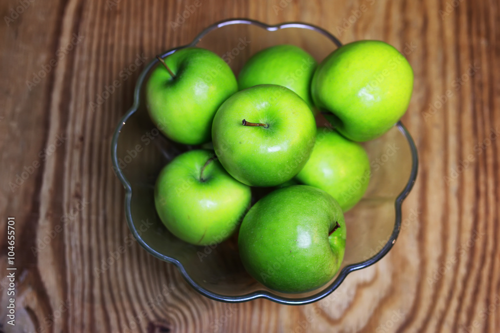 green apple in a glass bowl wooden background green apple in a glass bowl wooden background