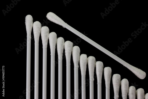 soft cotton swabs on black background