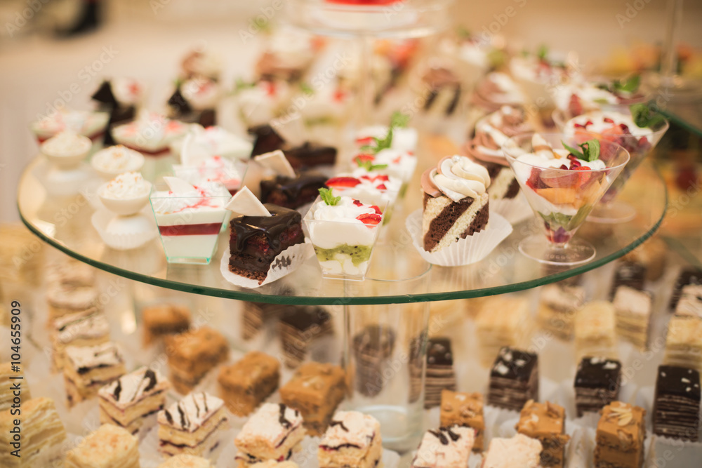 Different delicious desserts and cakes on the buffet table Different delicious desserts and cakes on the buffet table