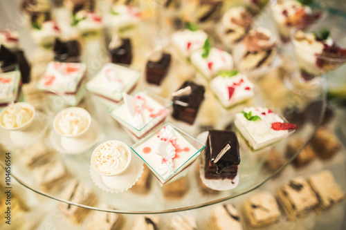 Different delicious desserts and cakes on the buffet table © olegparylyak