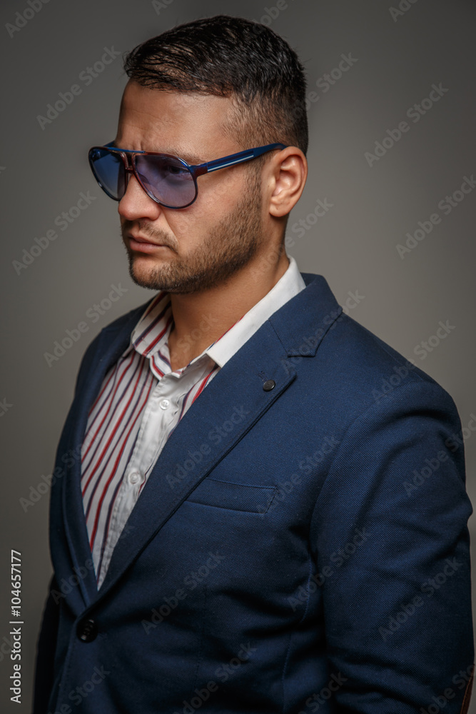 Portrait of a casual man in a blue sunglasses. Portrait of a casual man in a blue sunglasses.