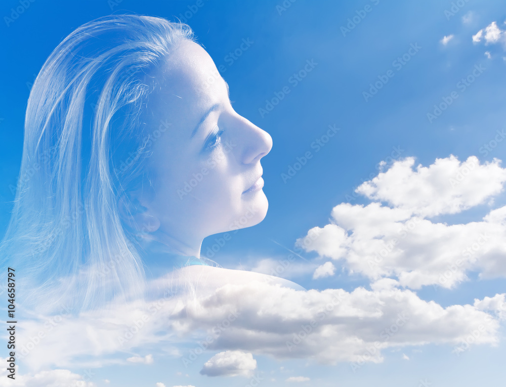 Abstract portrait of a young woman against the sky