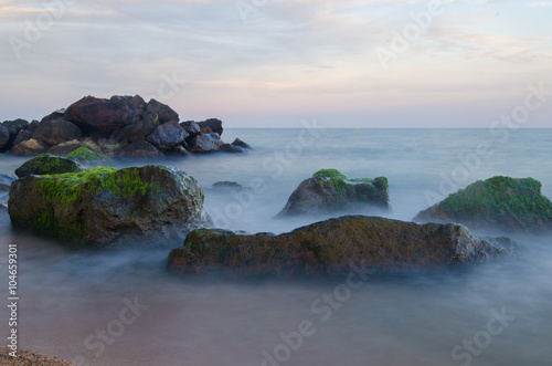 Evening sea with rocks and long exposure  