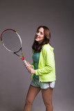 Healthy sporty girl with tennis racket