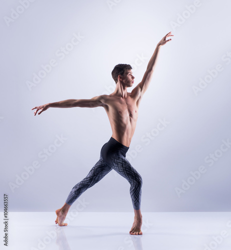 Athletic ballet dancer performing in a studio