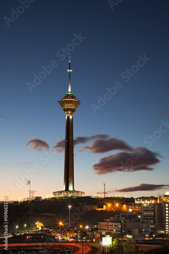 Milad Tower in the Skyline of Tehran at Dusk Against Cloudy Blue Sky photo