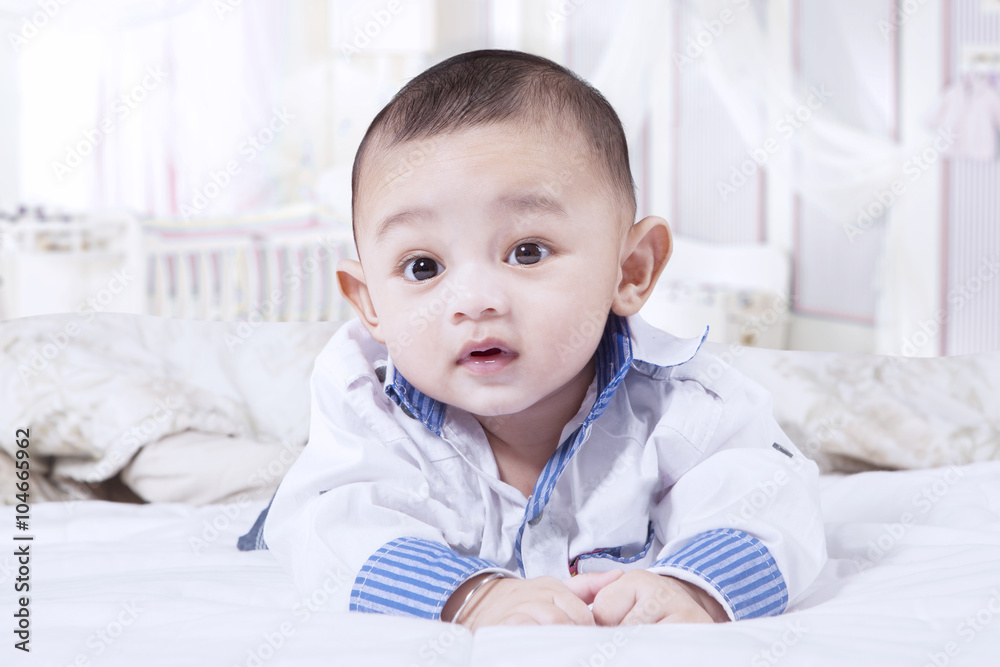 Cute baby boy crawling in the bedroom Cute baby boy crawling in the bedroom