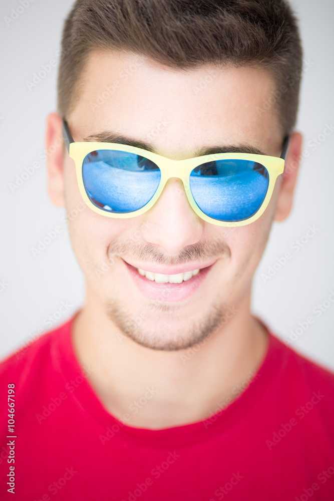 Young man with colored sunglasses