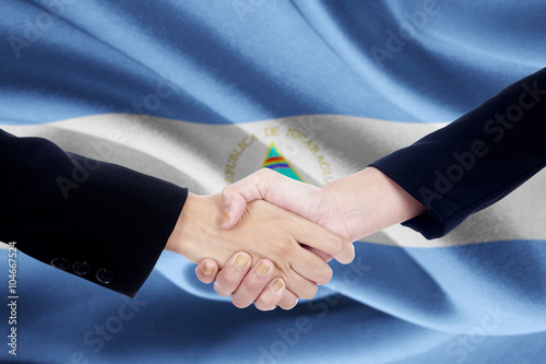 Partnership handshake with flag of Nicaragua