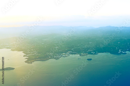 View outside of an airplane window to Ibiza Island. Sunset scene with copy space.