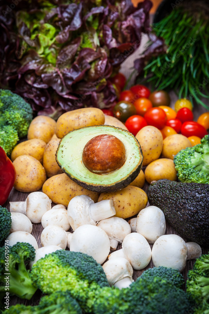 Assorted raw vegetables on wooden background