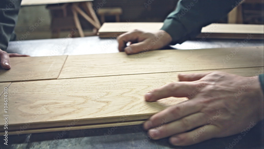 Joiners try on each other's board density. Handmade floor of wood. RAW video record, Joiners try on each other's board density. Handmade floor of wood. RAW video record,