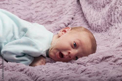 Adorable newborn baby with funny face