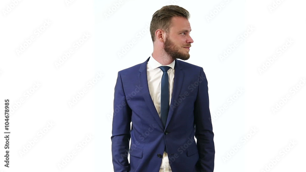 An attractive businessman in a blue suit, white shirt and blue tie, standing looking at camera with a white background. Focused and intense. An attractive businessman in a blue suit, white shirt and blue tie, standing looking at camera with a white background. Focused and intense.
