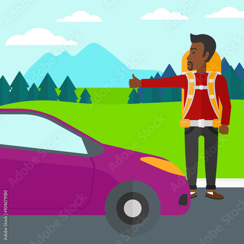 Young man hitchhiking.
