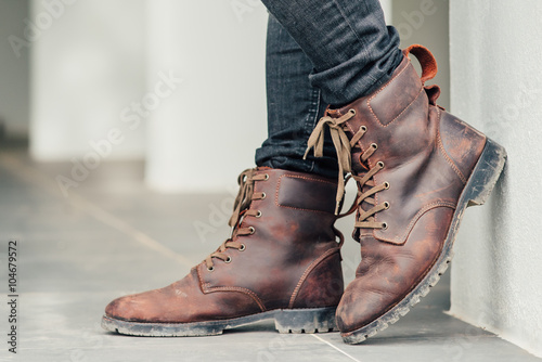 Men fashion, brown leather boots and blue jeans