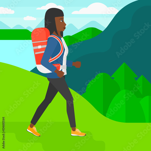 Woman with backpack hiking. © Visual Generation