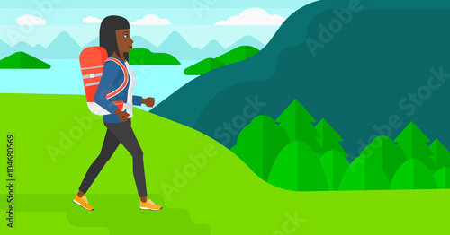 Woman with backpack hiking.