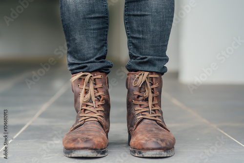 Men fashion, brown leather boots and blue jeans