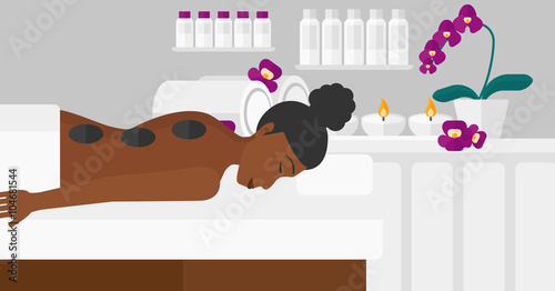 Woman getting stone therapy.