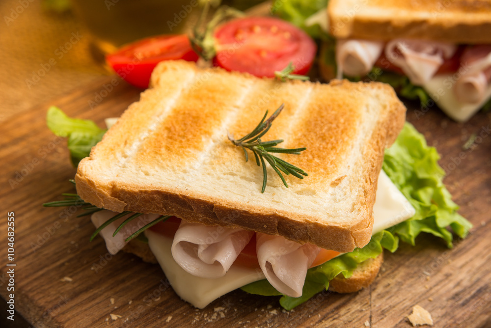 Toasted sandwich with bacon, cheese, tomato and lettuce Toasted sandwich with bacon, cheese, tomato and lettuce